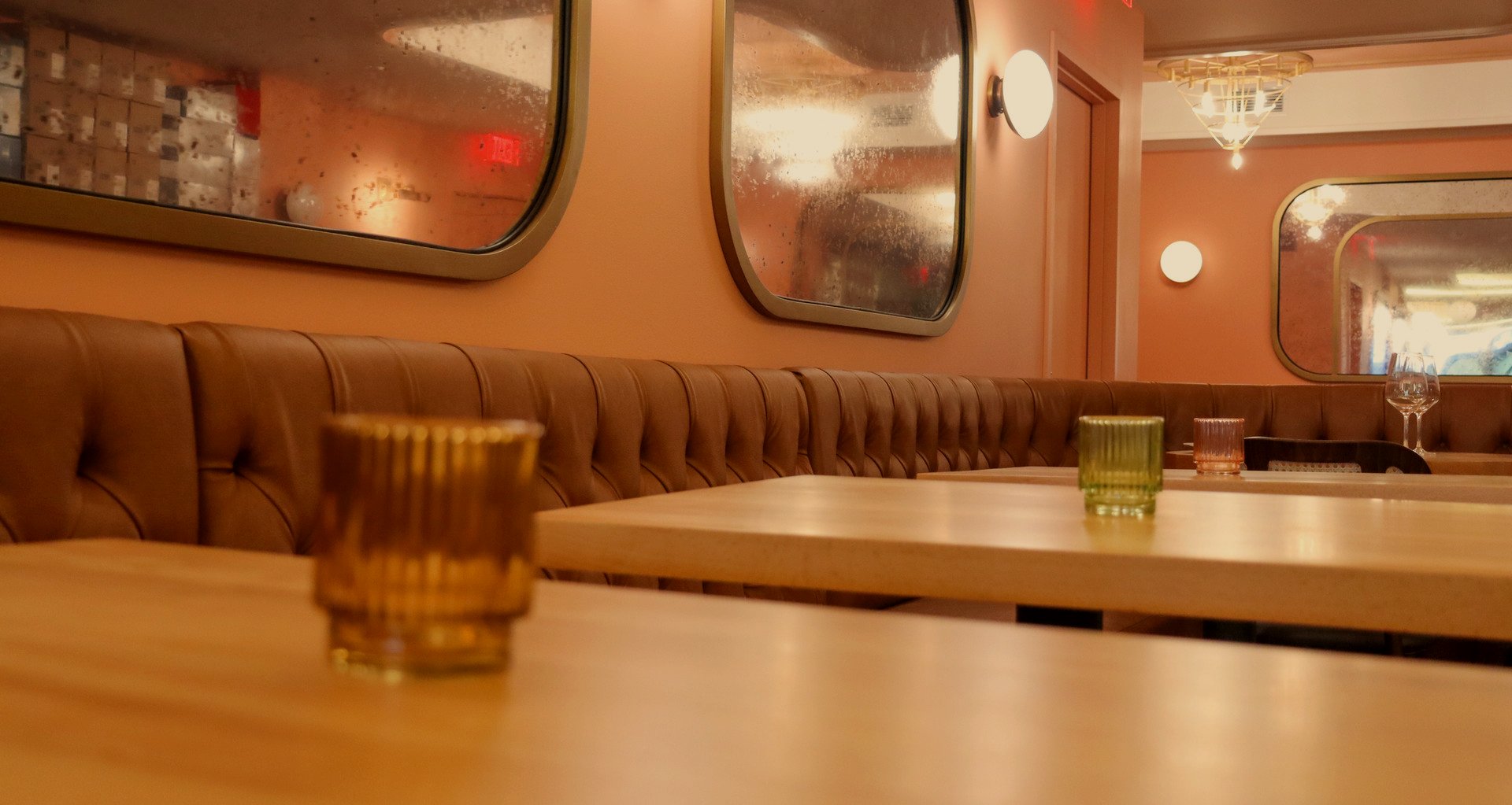 Tufted banquettes with warm candlelight at Jolene's